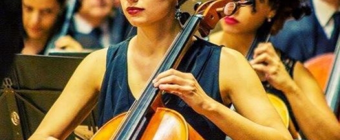 photo of woman playing cello, with other performers in background