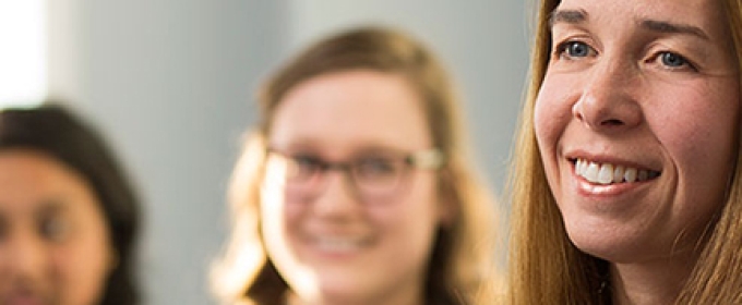 woman with two students in the background, photo