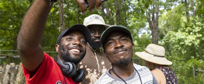 photo of three men taking a selfie, with trees, day