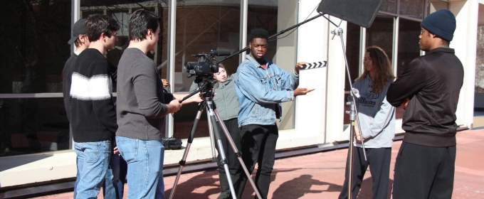 photo of film shoot with camera, people, clapper board, outdoors day