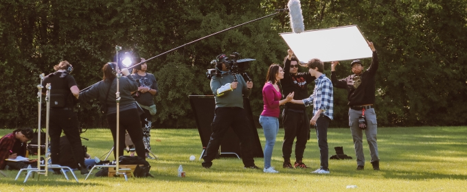 photo of people working on film set, outdoors, day