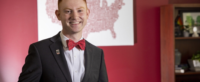 photo of man, map on wall in background