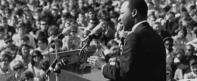 black and white photo of man speaking before a crowd