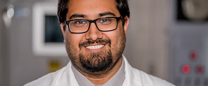 photo of man in lab coat and tie