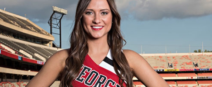 cheerleader in uniform with stadium