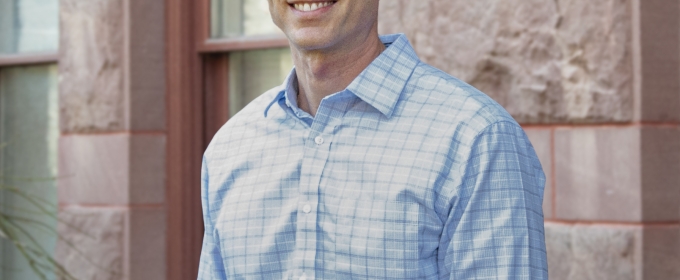 photo of man, building in background