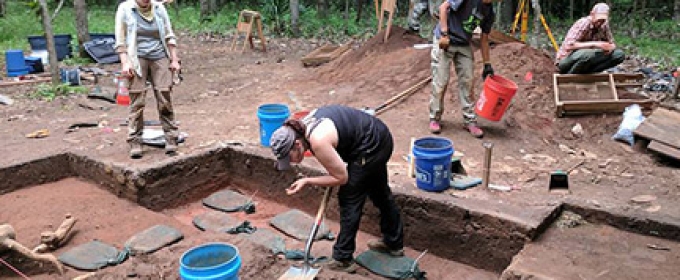 students working on archeological excavation