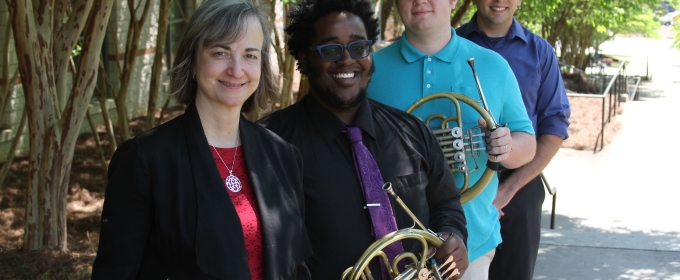 photo of four musicians, two holding horns