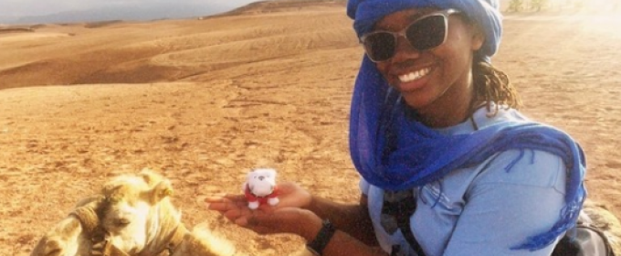 photo of woman with camel, desert in background
