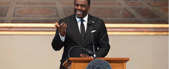 photo of man speaking at podium
