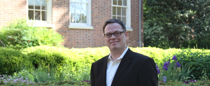 photo of man outdoors adjacent to brick building