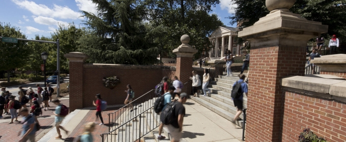 photo of people walking up steps, sunny day