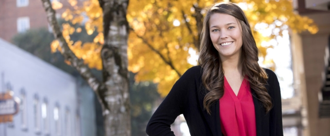 photo of woman outdoors with tree and fall foliage