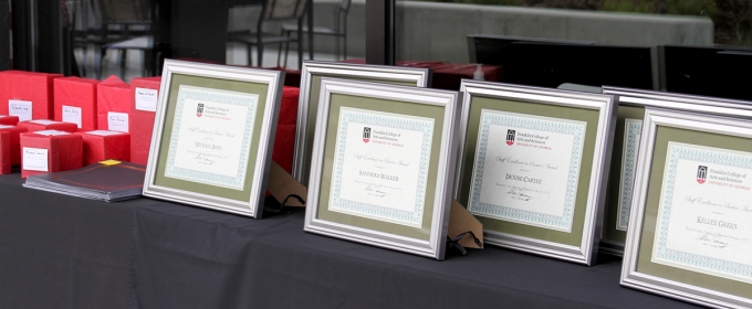 photo of table with framed certificates