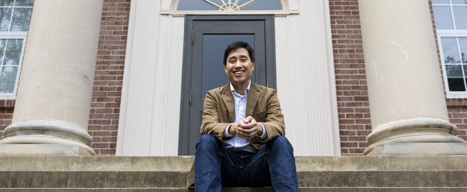 photo of man sitting on building steps 