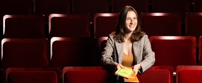 photo of woman sitting in theatre seats