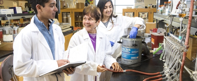 photo of three people in white lab coats, laboratory