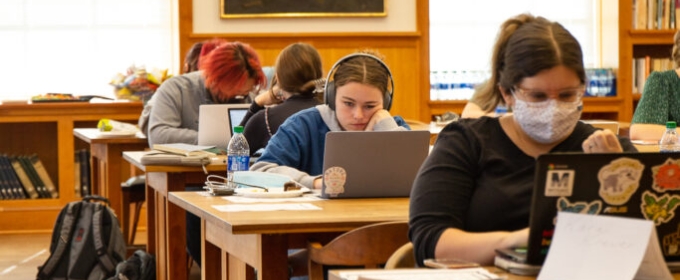 photo of students with computers in library 