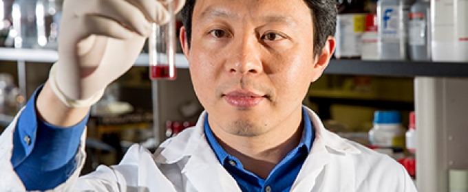 man in lab with test tube