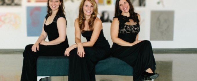 photo of three women on a bench, with paintings