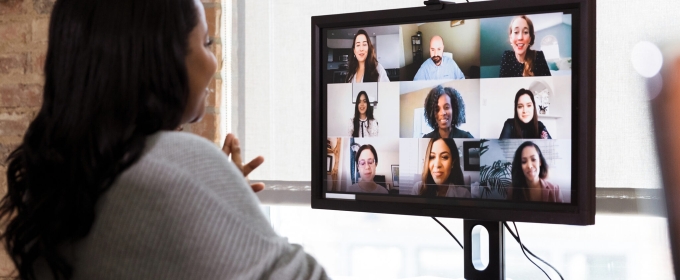 photo of woman looking at computer screen with faces