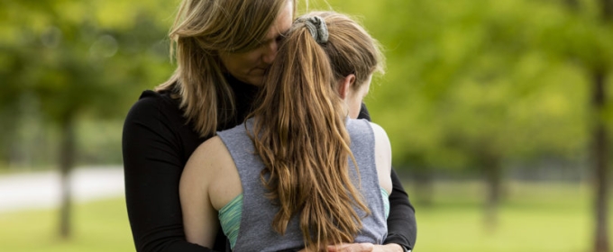 photo of woman and girl in embrace