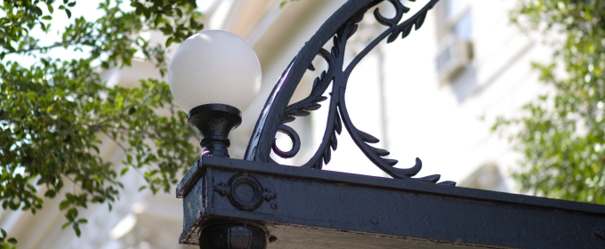 photo of architectural detail of arch, day, with trees in background