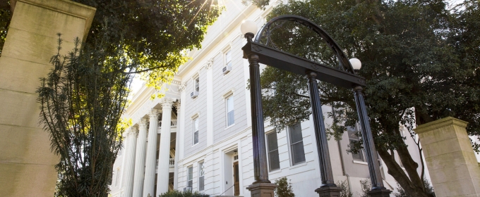 photo of arch, building in background, day