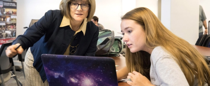 photo of two women with a computer 