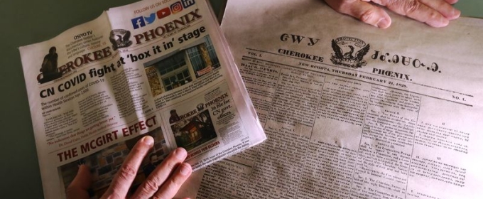 photo of hands and two newspapers in different languages