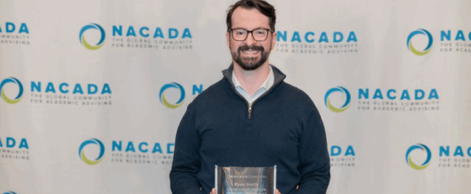 photo of man holding plaque