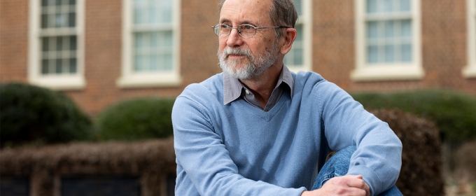 photo of man, with building in background