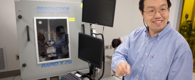 photo of man with computer and diagnostic machine