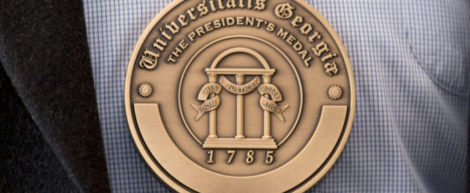 photo of engraved medal, shirt and jacket