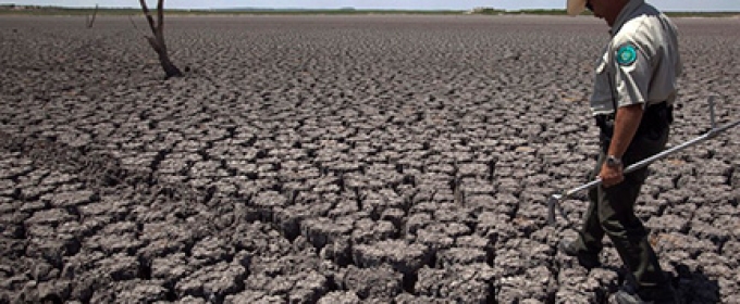 man walking on dried ground