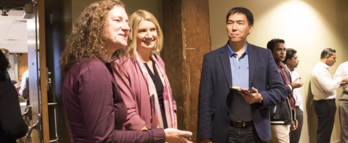 photo of several people speaking at an event