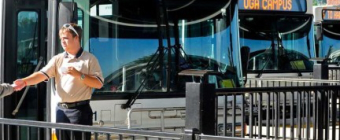 man in front of buses