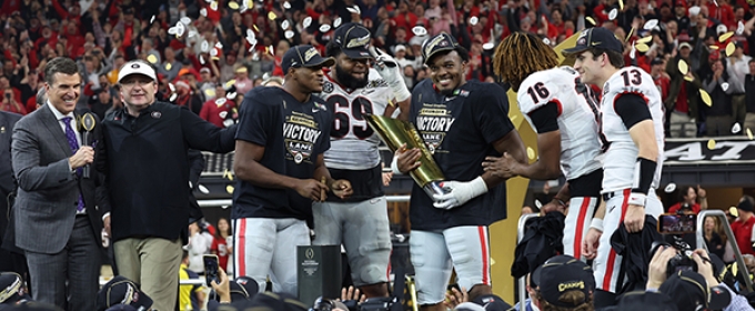 photo of football players on stage, with confetti and trophy