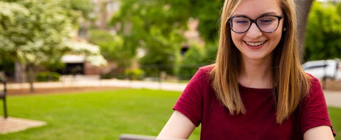 photo of woman outdoors with laptop computer