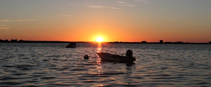 sunset with boat and water