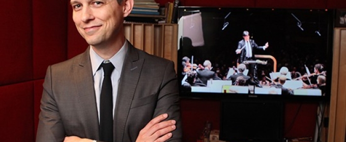 photo of man in sound booth with video screen