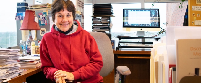 photo of woman in office, with windows, day