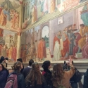 students looking at mural