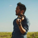 photo of man with violin, with open sky background