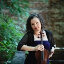 photo of woman holding viola, outdoors