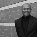 black and white photo of man with wall